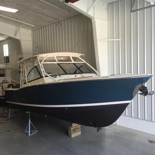  Yacht Photos Pics 2016 Grady-White Freedom 307 boat in storage, blue hull, indoor facility.