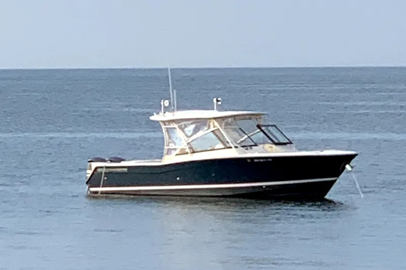  Yacht Photos Pics 2016 Grady-White Freedom 307 boat on calm ocean waters.