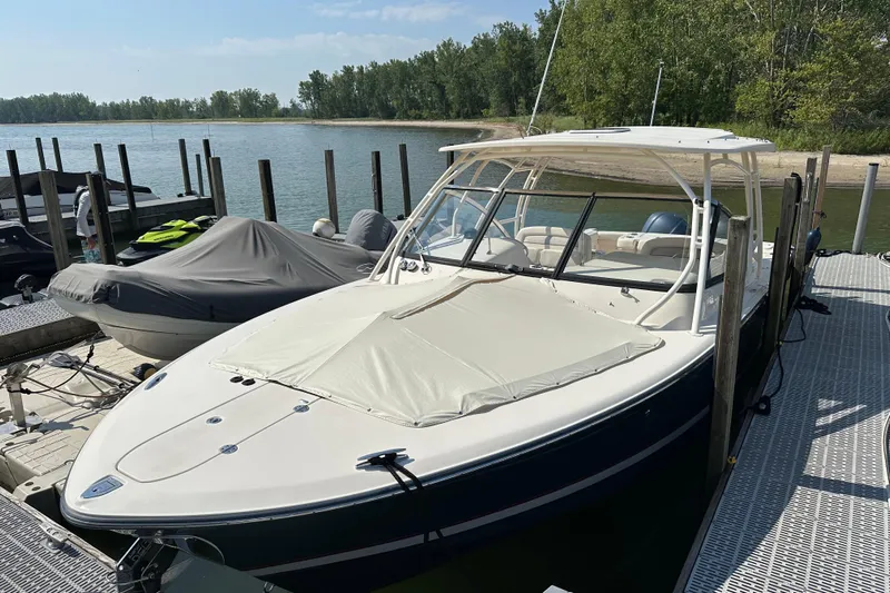 Yacht Photos Pics 2016 Grady-White Freedom 307 boat docked by a serene lakeside.