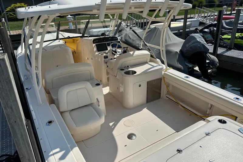  Yacht Photos Pics 2016 Grady-White Freedom 307 boat interior with seating and helm at dock.