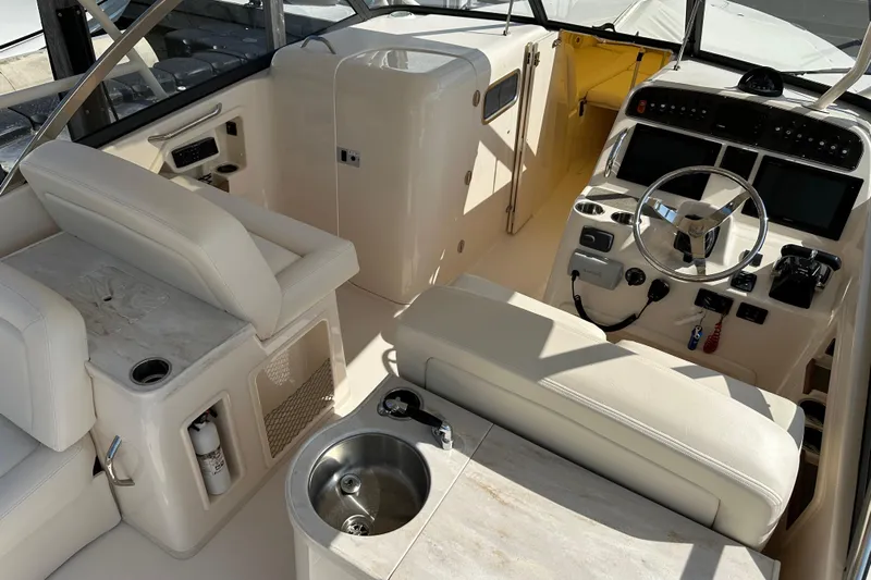  Yacht Photos Pics 2016 Grady-White Freedom 307 boat interior with helm, seating, and sink.