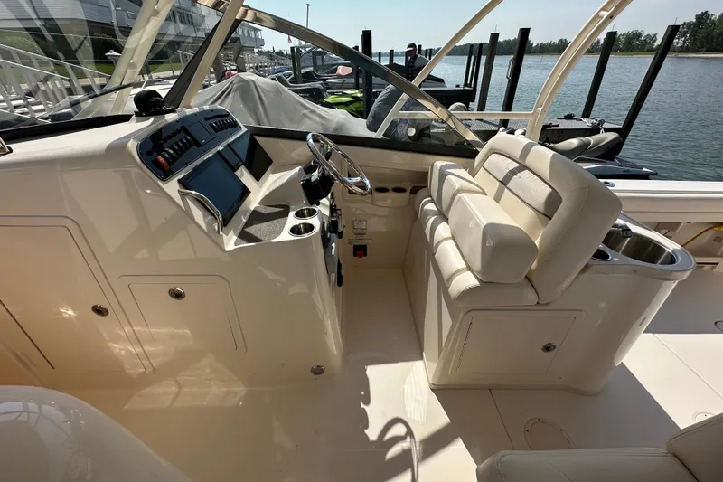  Yacht Photos Pics 2016 Grady-White Freedom 307 boat interior with helm, seating, and controls.