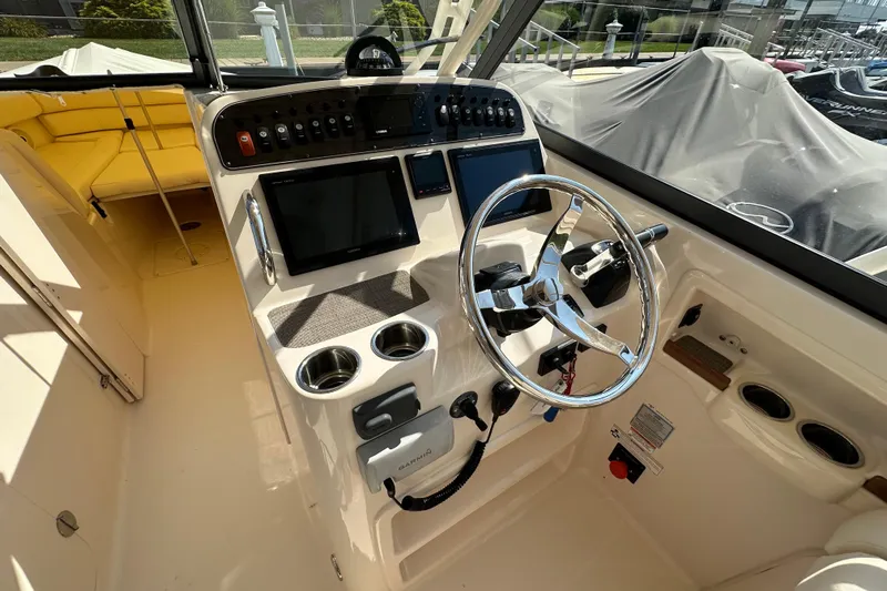  Yacht Photos Pics 2016 Grady-White Freedom 307 boat cockpit with steering wheel and navigation controls.
