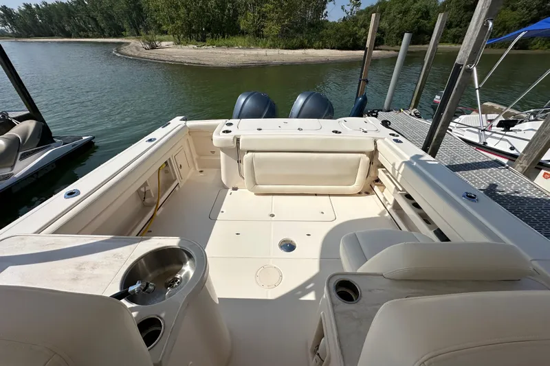  Yacht Photos Pics 2016 Grady-White Freedom 307 boat interior at dock, featuring seating and sink.