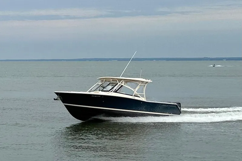  Yacht Photos Pics 2016 Grady-White Freedom 307 boat cruising on calm waters.