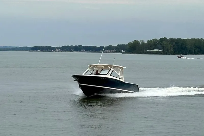  Yacht Photos Pics 2016 Grady-White Freedom 307 boat cruising on a calm lake.