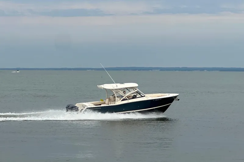  Yacht Photos Pics 2016 Grady-White Freedom 307 boat cruising on open water.
