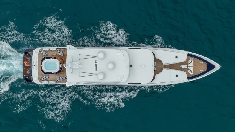 Focus Yacht Photos Pics Aerial view of 2002 North American Tri-Deck Motor Yacht cruising on blue ocean waters.