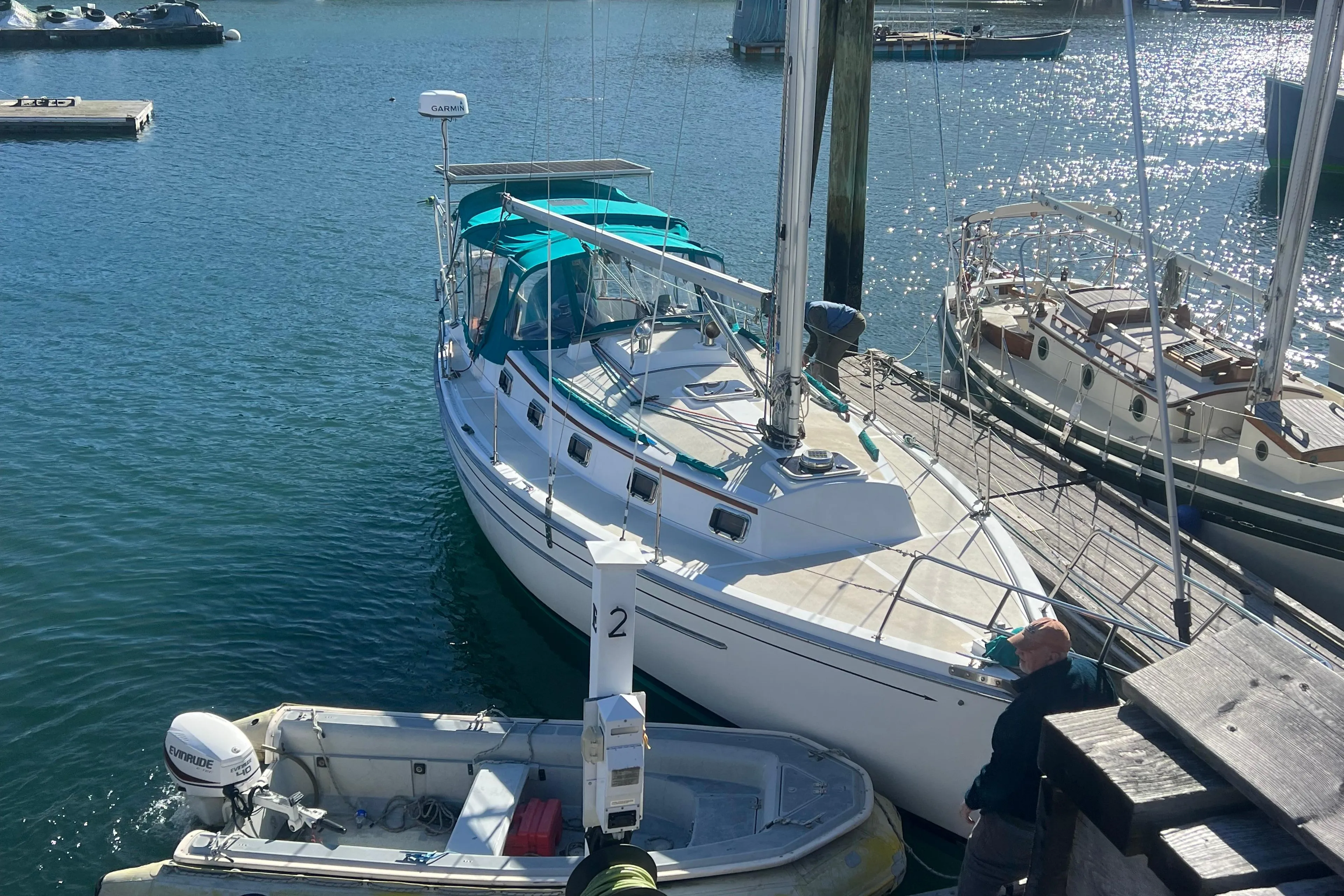 1993 Compac Sloop docked at marina, with clear blue water and nearby boats.