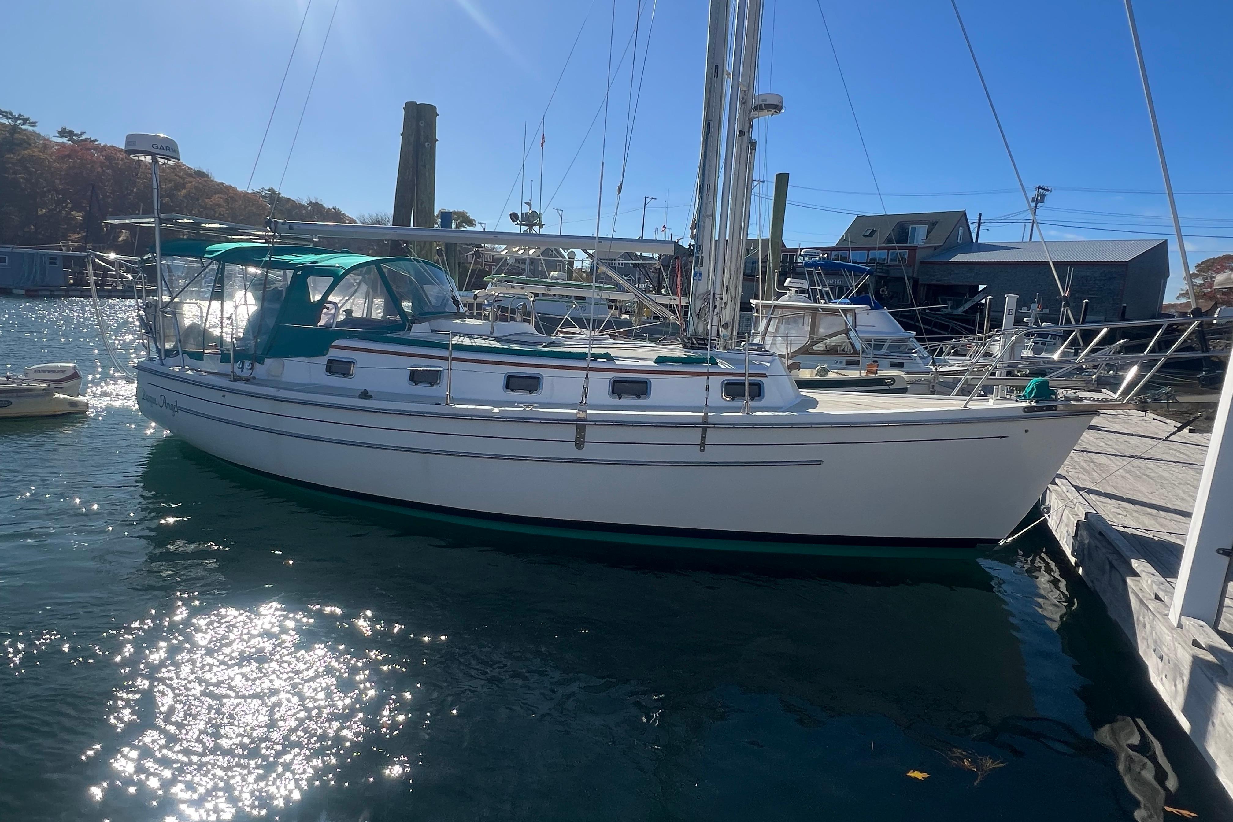 1993 Compac Sloop sailboat docked in sunny marina, featuring green canopy.