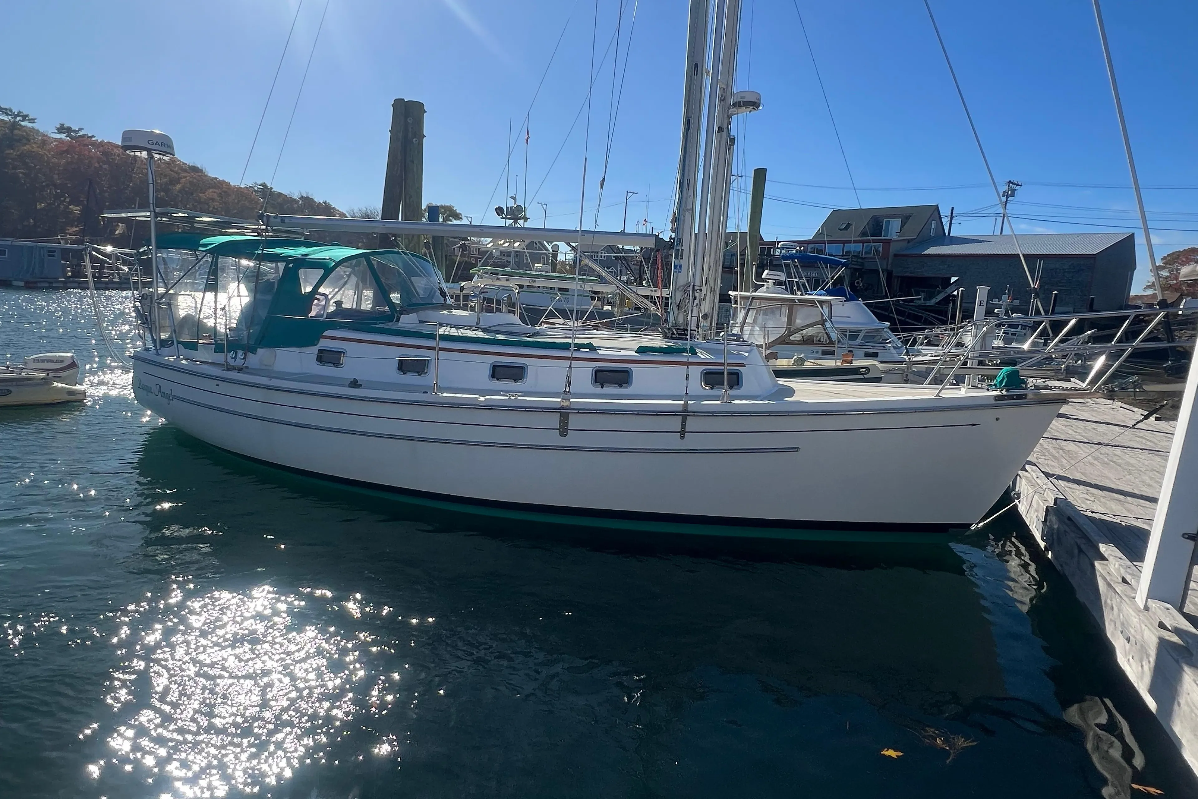 1993 Compac Sloop sailboat docked in sunny marina, featuring green canopy.
