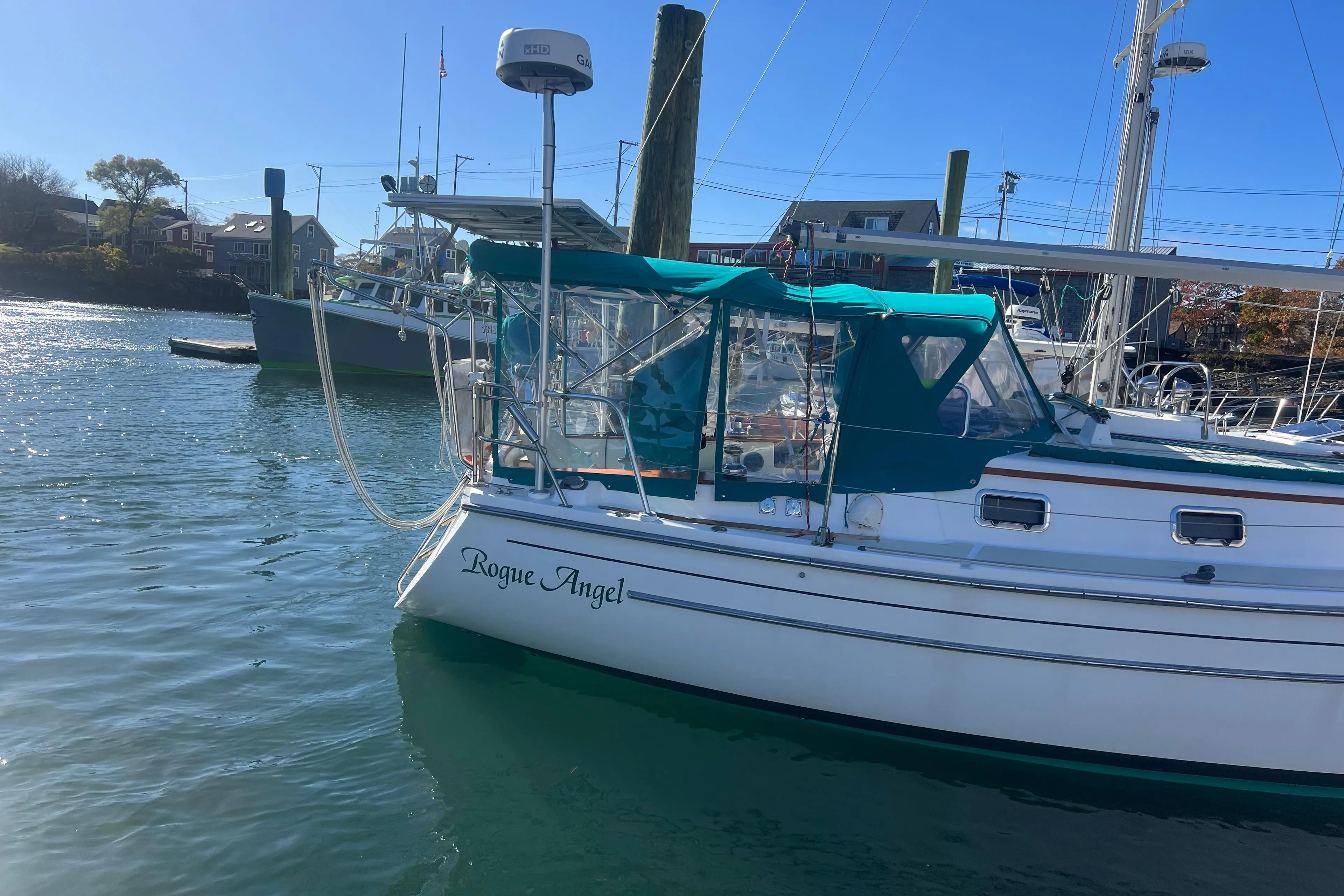 1993 Compac Sloop "Rogue Angel" docked in sunny marina, clear blue sky.