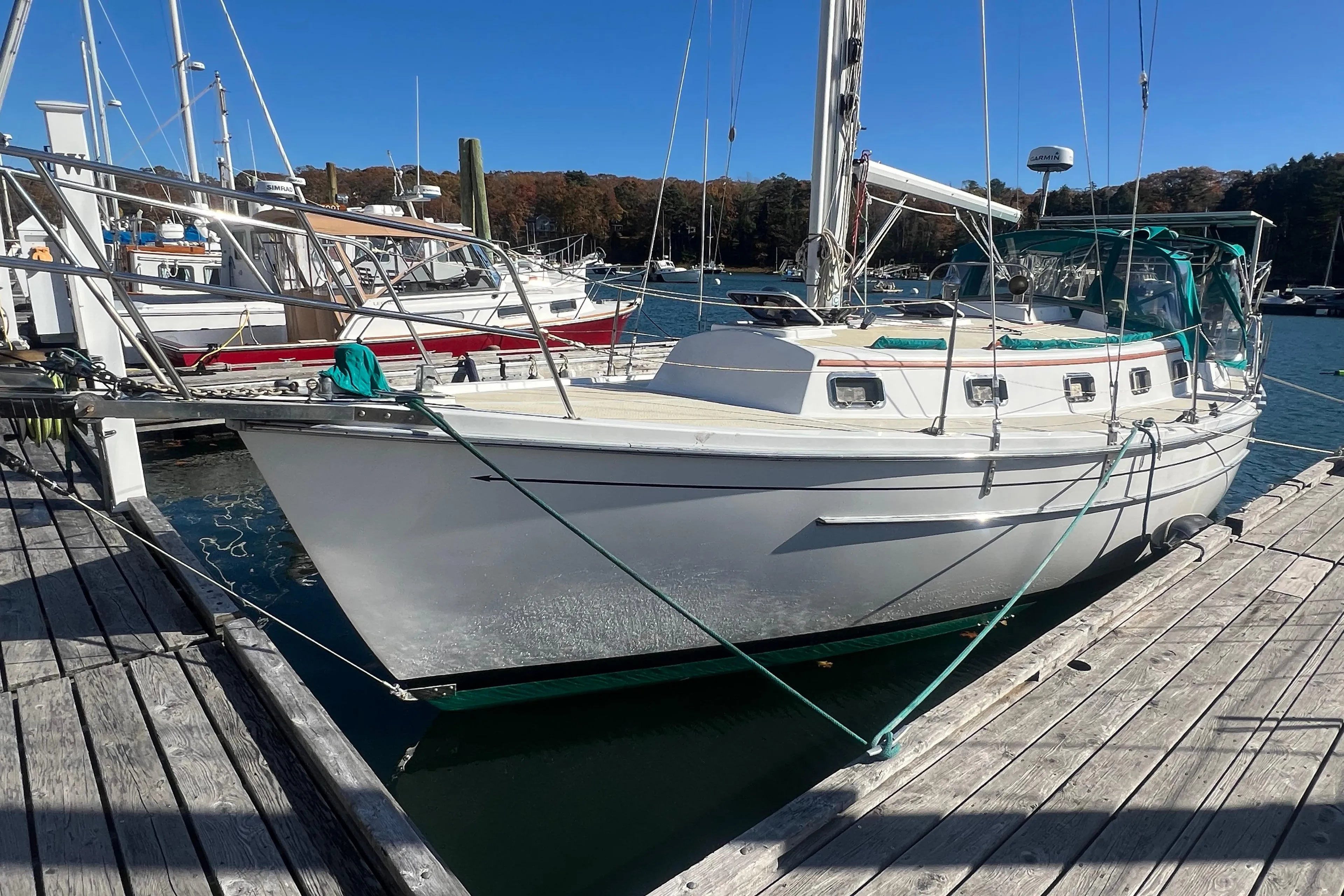 1993 Compac Sloop docked at a marina on a sunny day.