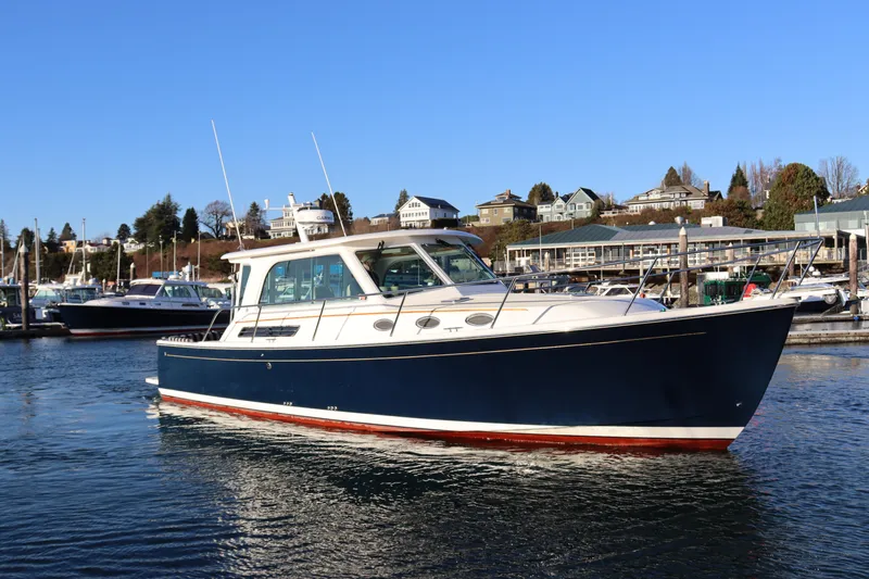 Someday Soon Yacht Photos Pics 2015 Back Cove 37 boat docked in a marina under clear blue skies.