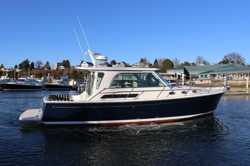 Someday Soon Yacht Photos Pics 2015 Back Cove 37 boat cruising on a sunny day near a marina.