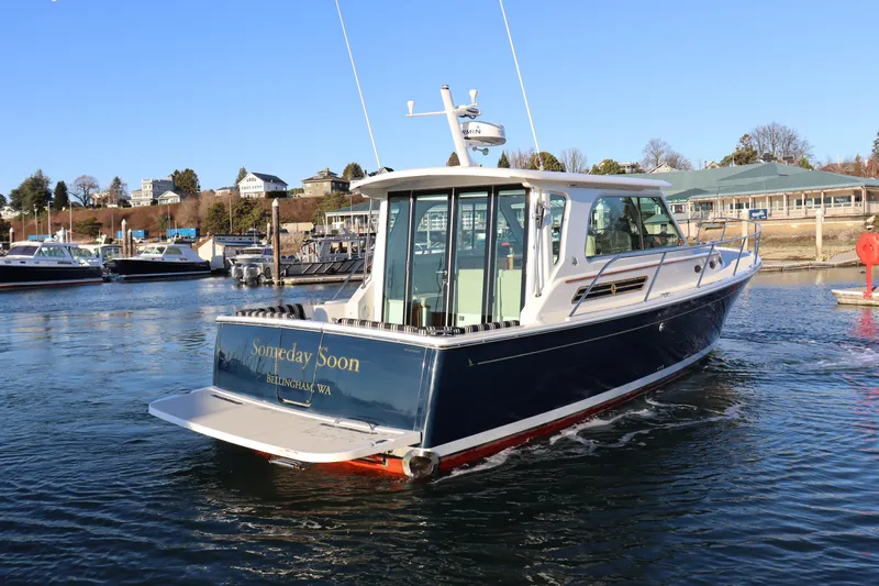 Someday Soon Yacht Photos Pics 2015 Back Cove 37 boat on water, sunny day, marina background.