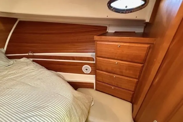Someday Soon Yacht Photos Pics 2015 Back Cove 37 cabin interior with wooden drawers and striped bedding.