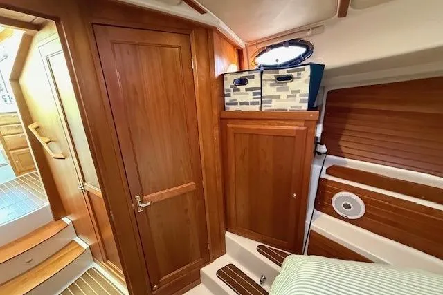 Someday Soon Yacht Photos Pics 2015 Back Cove 37 interior with wooden cabinetry and cozy seating area.
