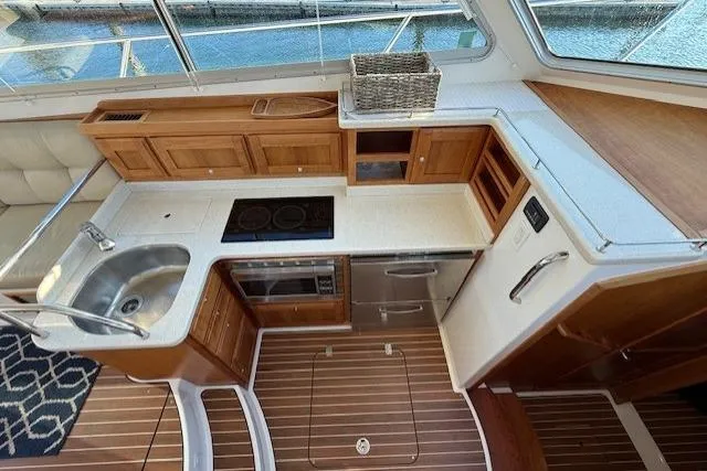 Someday Soon Yacht Photos Pics Luxurious 2015 Back Cove 37 yacht kitchen with wood cabinetry and modern appliances.