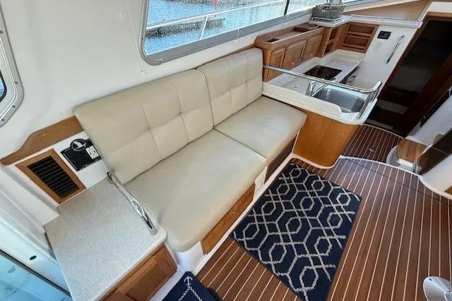 Someday Soon Yacht Photos Pics Interior of 2015 Back Cove 37 yacht with seating and wooden flooring.