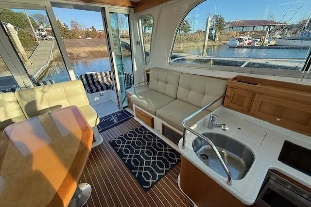 Someday Soon Yacht Photos Pics Interior of 2015 Back Cove 37 yacht with seating, table, and kitchenette.