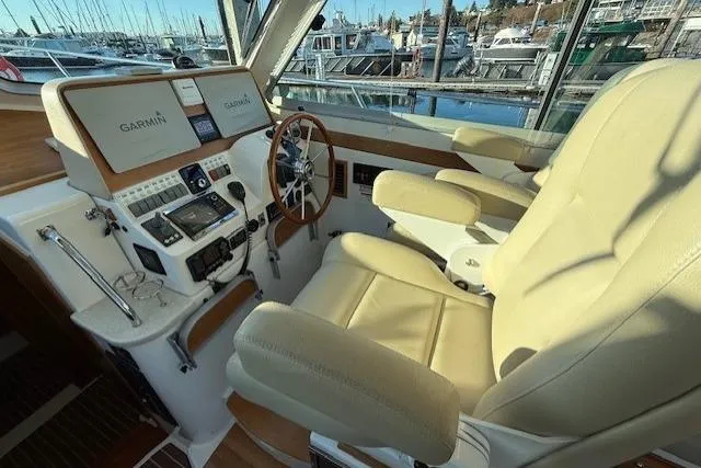 Someday Soon Yacht Photos Pics 2015 Back Cove 37 helm with Garmin navigation, leather seats, and marina view.