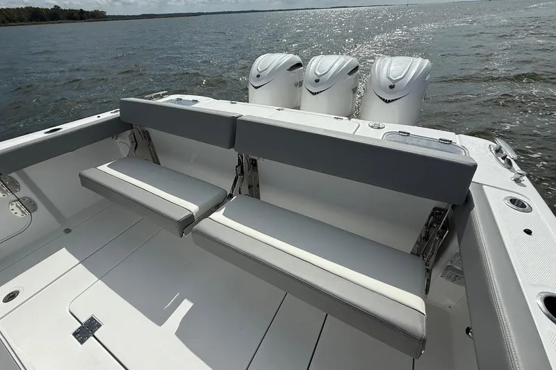  Yacht Photos Pics 2026 Everglades 375 Center Console boat with triple engines and foldable seating on open water.