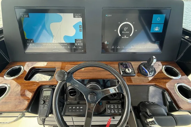  Yacht Photos Pics 2026 Everglades 375 Center Console dashboard with dual Garmin displays and sleek wood finish.