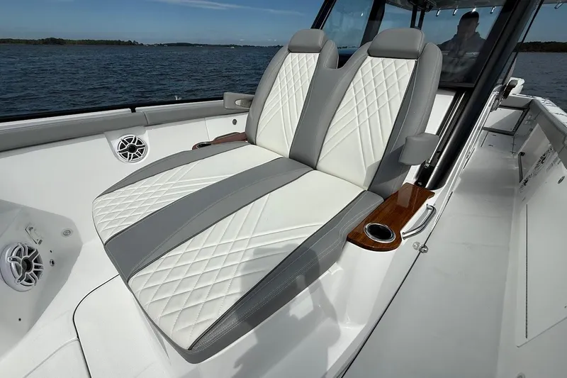  Yacht Photos Pics Luxury seating on 2026 Everglades 375 Center Console boat, featuring elegant design and ocean backdrop.