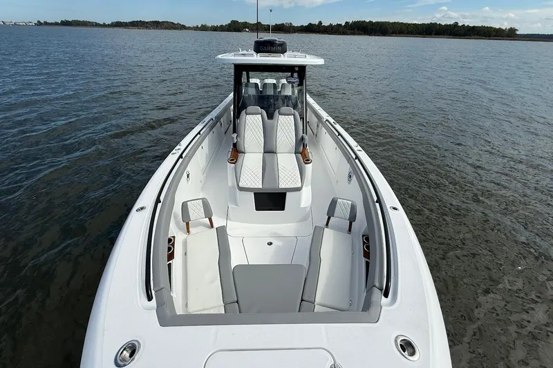  Yacht Photos Pics 2026 Everglades 375 Center Console boat on calm water, showcasing spacious seating and sleek design.