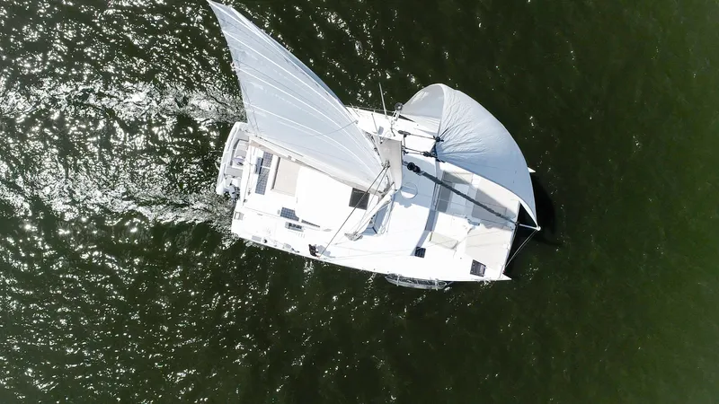 Cinders Yacht Photos Pics Aerial view of 2020 Bali 5.4 catamaran sailing on open water.