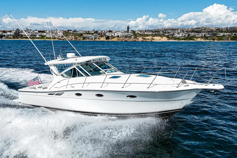 Wave Length Yacht Photos Pics 2001 Tiara Yachts 3500 Open cruising on the ocean with coastal scenery in the background.