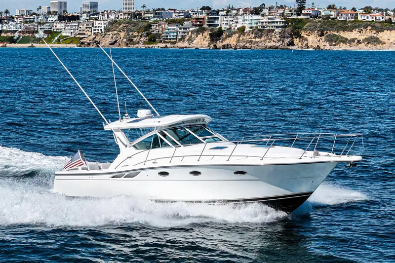 Wave Length Yacht Photos Pics 2001 Tiara Yachts 3500 Open cruising on ocean near coastal cityscape.