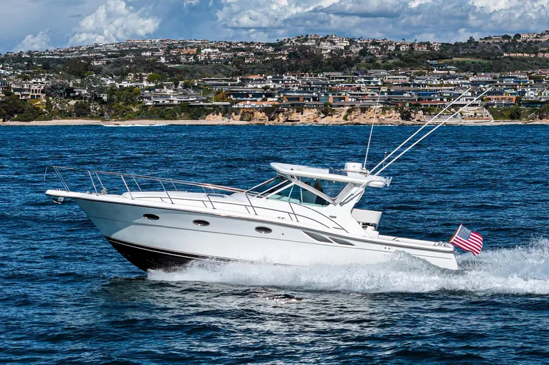 Wave Length Yacht Photos Pics 2001 Tiara Yachts 3500 Open cruising on the ocean with coastal cityscape in background.