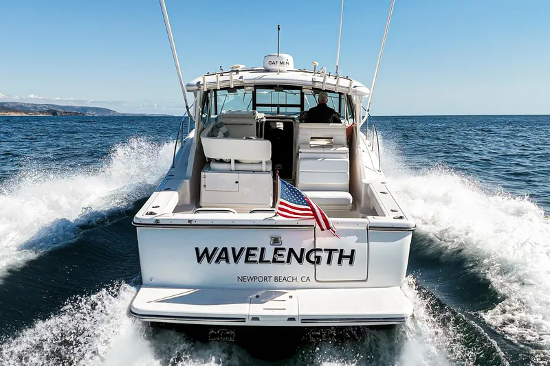Wave Length Yacht Photos Pics 2001 Tiara Yachts 3500 Open cruising with American flag, Newport Beach, CA.
