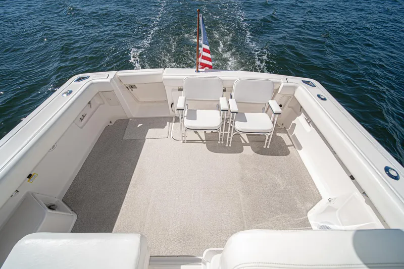 Wave Length Yacht Photos Pics 2001 Tiara Yachts 3500 Open deck with chairs, American flag, and ocean view.