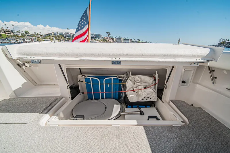 Wave Length Yacht Photos Pics 2001 Tiara Yachts 3500 Open storage compartment with American flag in background.
