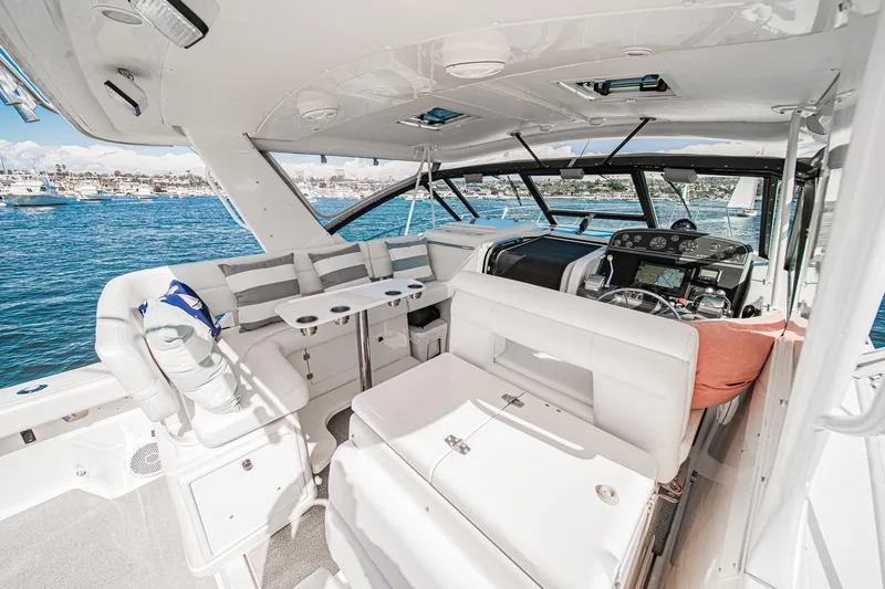 Wave Length Yacht Photos Pics Interior of 2001 Tiara Yachts 3500 Open, featuring luxurious seating and helm, overlooking the ocean.