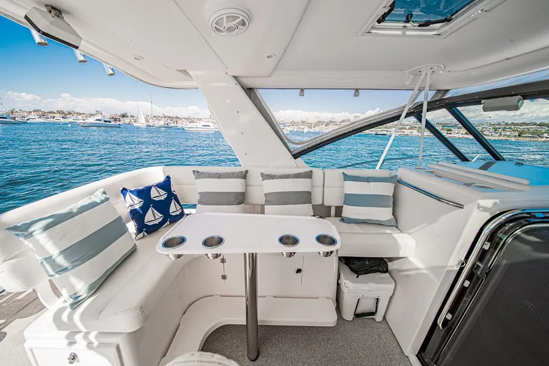 Wave Length Yacht Photos Pics Interior of 2001 Tiara Yachts 3500 Open with seating and table, overlooking the ocean.