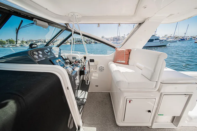 Wave Length Yacht Photos Pics 2001 Tiara Yachts 3500 Open interior with helm and seating, docked in a marina.