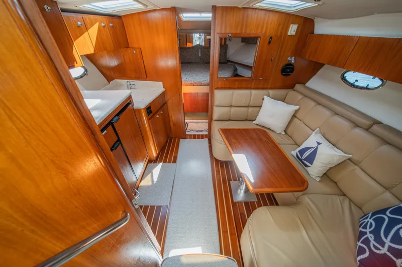 Wave Length Yacht Photos Pics 2001 Tiara Yachts 3500 Open interior with wood finish, seating area, and kitchenette.