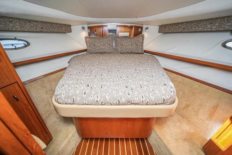 Wave Length Yacht Photos Pics Luxurious cabin interior of 2001 Tiara Yachts 3500 Open with cozy bed and wood accents.