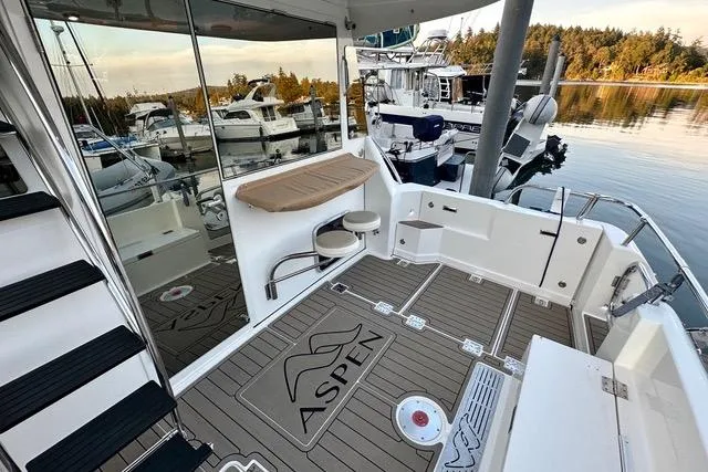 Topcat Yacht Photos Pics Aspen C120 2022 boat interior with seating, docked at marina, scenic water view.