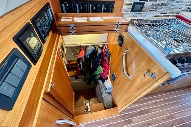 Topcat Yacht Photos Pics Interior of 2022 Aspen C120 boat with wooden cabinetry and control panels.