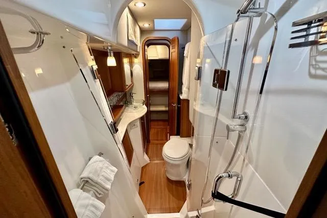 Topcat Yacht Photos Pics Luxurious bathroom in 2022 Aspen C120 yacht with modern fixtures and elegant wood accents.