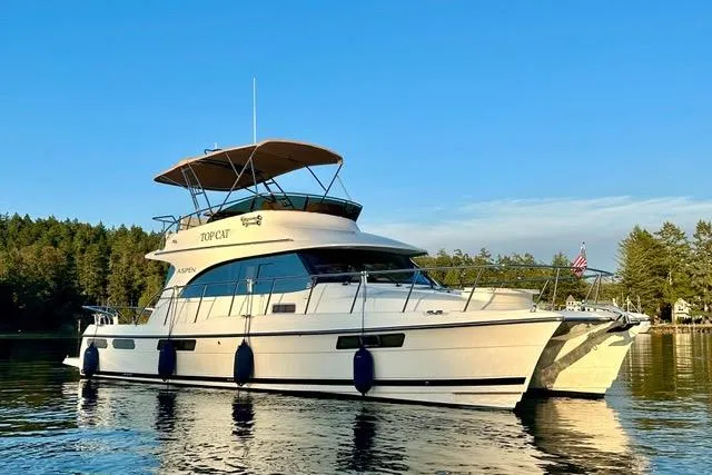 Topcat Yacht Photos Pics 2022 Aspen C120 yacht on calm water, featuring sleek design and spacious deck.