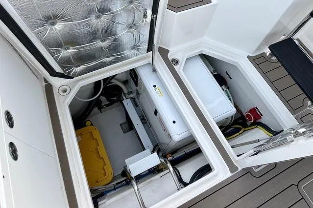 Topcat Yacht Photos Pics Engine compartment of 2022 Aspen C120 boat, showcasing mechanical components and storage areas.