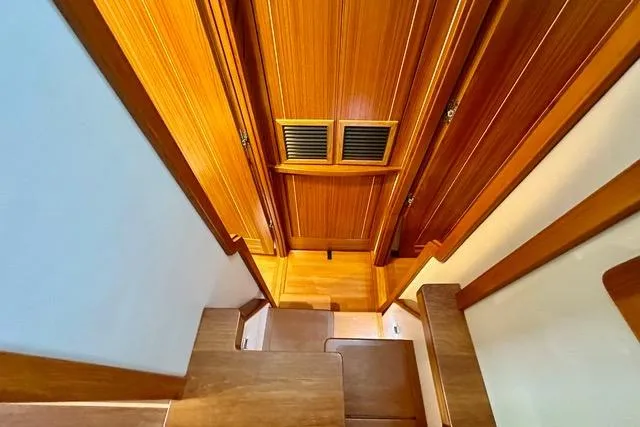 Topcat Yacht Photos Pics Wooden interior stairs of 2022 Aspen C120 boat, featuring elegant design and craftsmanship.