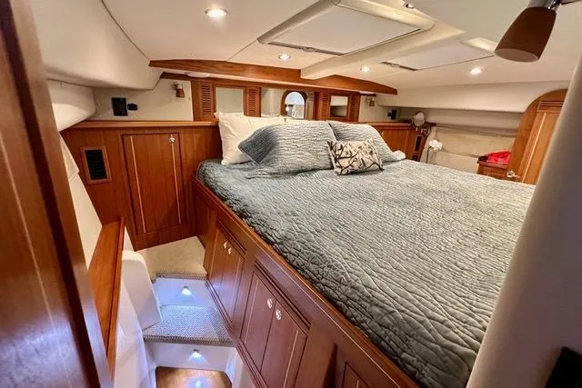 Topcat Yacht Photos Pics Luxurious 2022 Aspen C120 yacht cabin with cozy bedding and elegant wood finishes.