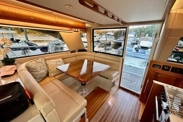 Topcat Yacht Photos Pics Luxurious interior of 2022 Aspen C120 yacht with elegant seating and wooden accents.
